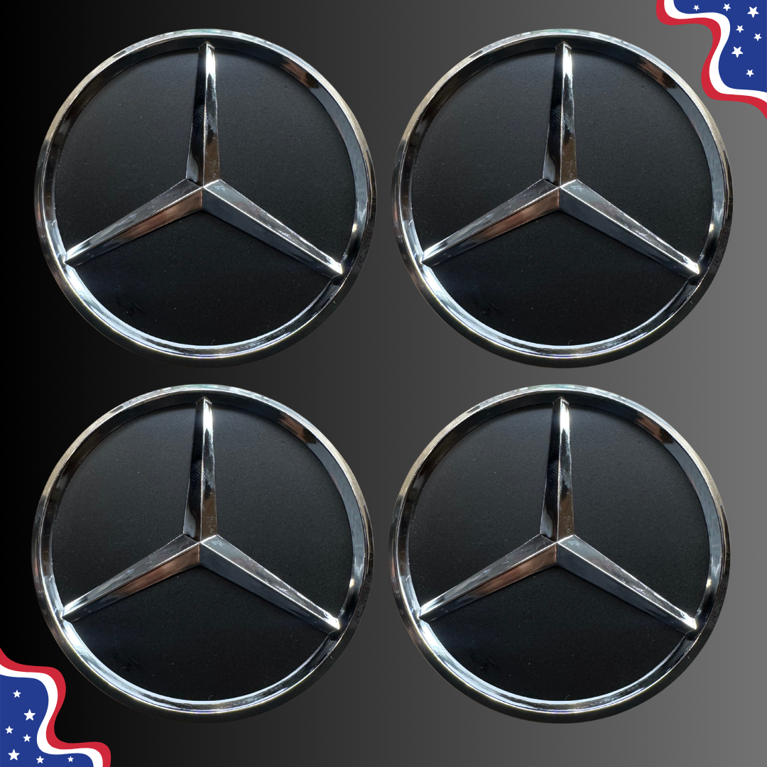 Four Mercedes-Benz three-pointed star emblems arranged in a 2x2 grid on a dark gray background, with small decorative American flag graphics in the top-right and bottom-left corners.